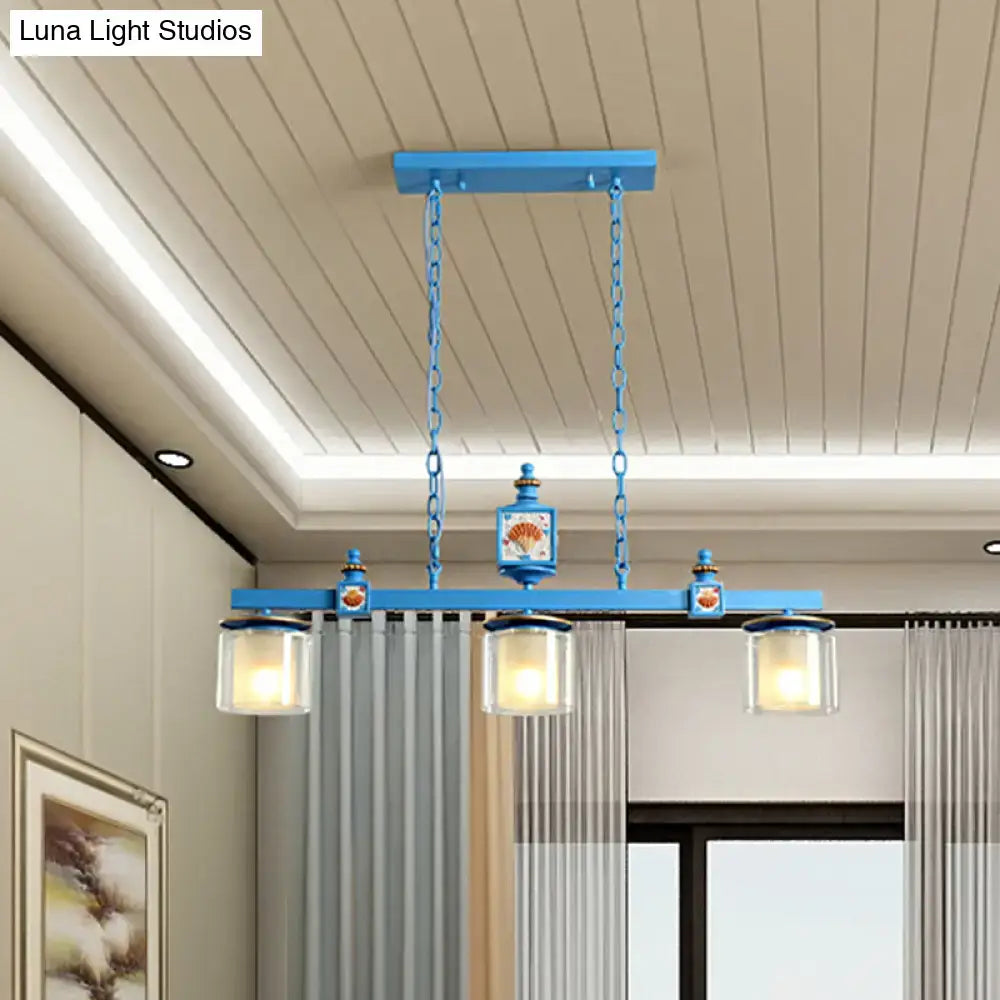 Blue metal DecorBites dual cylinder parlor island pendant lamp with three glass shades and decorative lantern fixtures