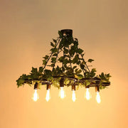DecorBites industrial metal pendant light in black with five filament bulbs and artificial ivy for 220v-240v and 110v-120v use