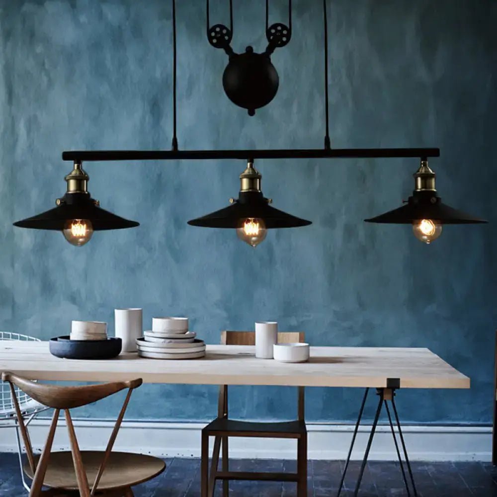 Decorbites industrial style metal island pendant light with black finish, brass accents, chain cord, and exposed bulbs