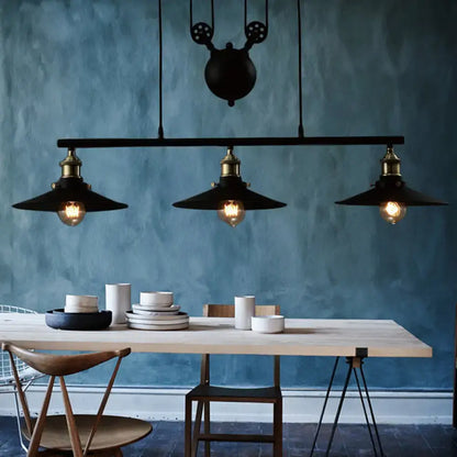 Decorbites industrial style metal island pendant light with black finish, brass accents, chain cord, and exposed bulbs