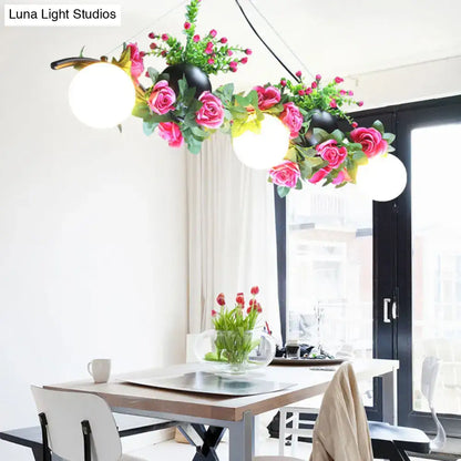 DecorBites industrial opal glass pendant light with three black flower heads and white spherical lights for dining room island