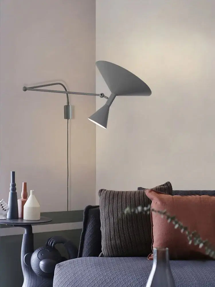 Modern gray industrial retro swing arm wall lamp with sleek angular design and two conical shades for bedroom use