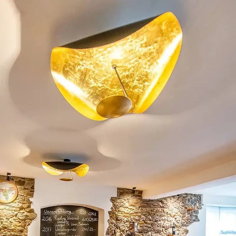 Golden curved industrial retro decorbites flying saucer ceiling lamp with textured translucent surface and black underside