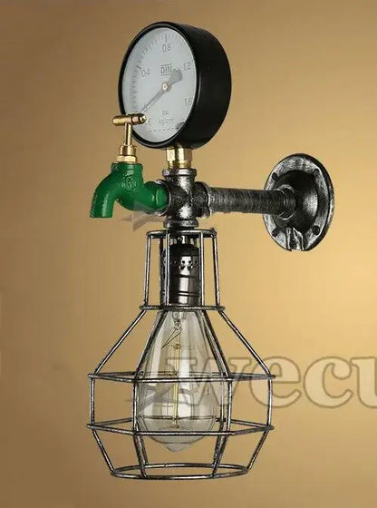 Industrial retro wall sconce with green faucet, black pressure gauge, brass fittings, and exposed edison bulb cage for decorbites