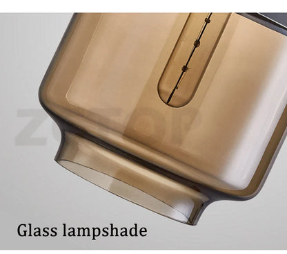 Amber-tinted glass led pendant light with sleek rectangular design and integrated filament bulb for dining room light source