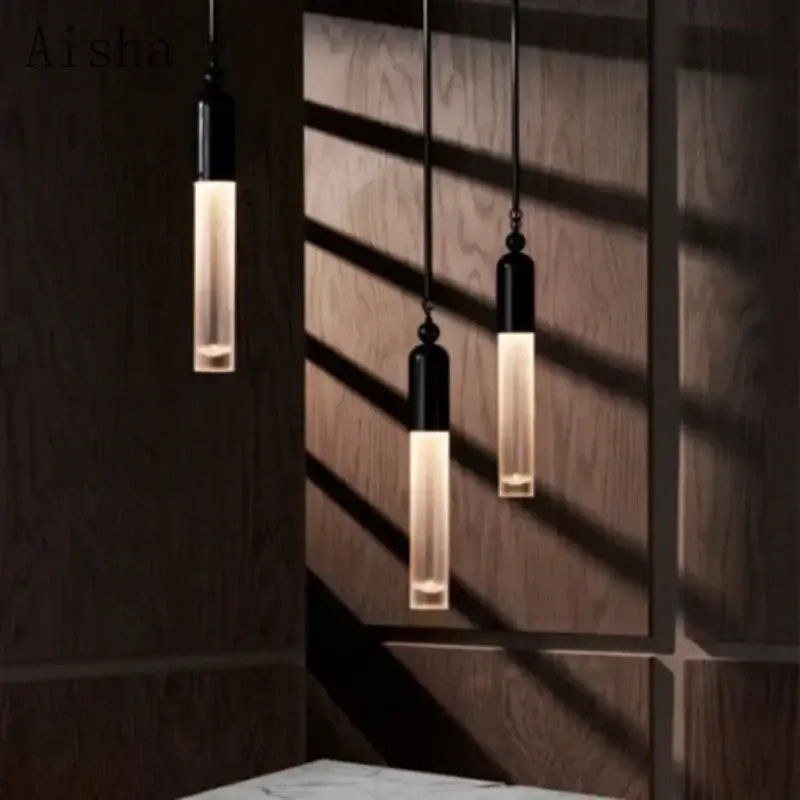 Three industrial retro pendant lamps with black metal tops and frosted glass emitting warm light for living room decorbites