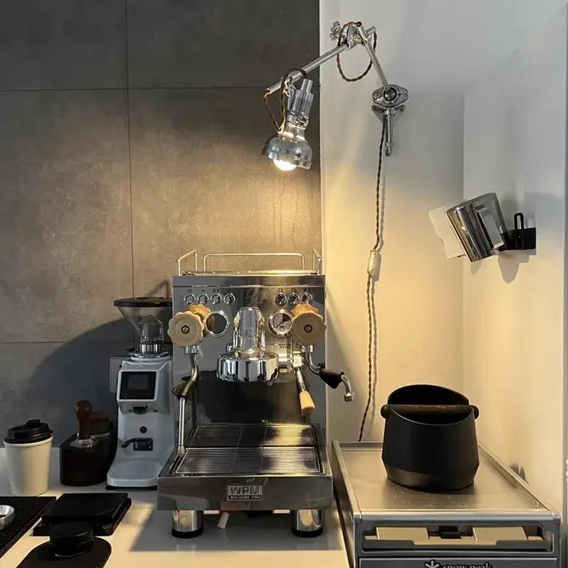 Industrial retro silver wall lamp with articulated sconce design complements stainless steel espresso machine decorbites industrial retro