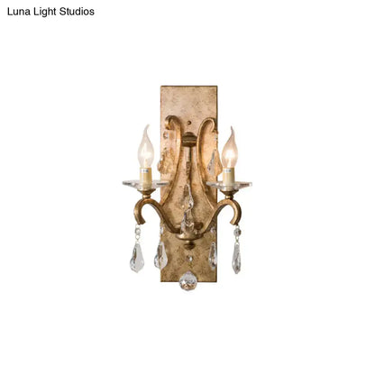 Antique gold-finished industrial rust iron wall sconce with e12 candle light and crystal teardrop pendants for bedroom