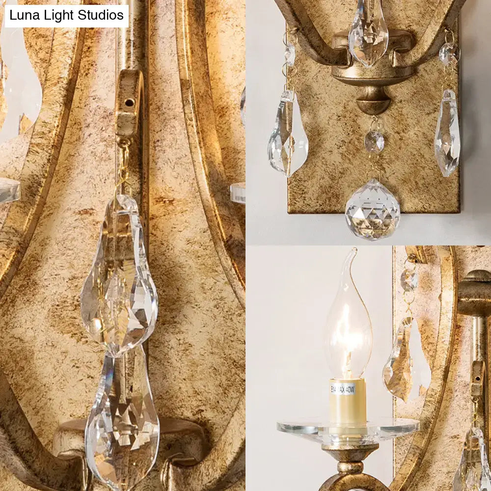 Antique gold-finished industrial rust iron wall sconce with e12 candle light and clear crystal droplets for bedroom use