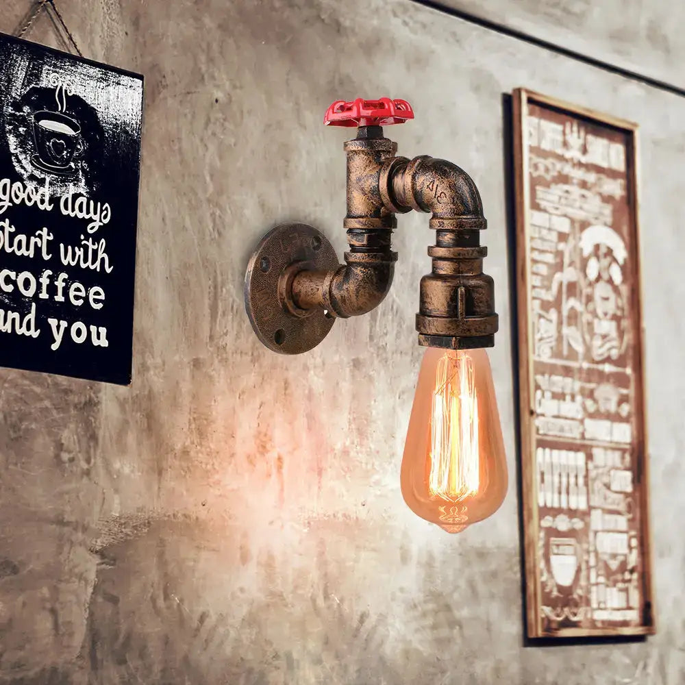 Industrial rusted iron water pipe wall lamp with brass finish, red valve handle, and exposed filament bulb by decorbites iron water