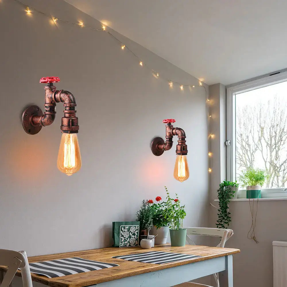 Industrial rusted iron water pipe wall lamp featuring copper pipe fittings and warm edison bulbs by decorbites iron water