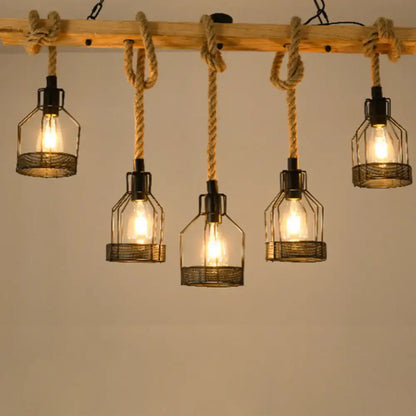 Industrial rustic hemp rope chandelier with five wire cage lamps suspended by thick hemp rope from wooden beam for dining room