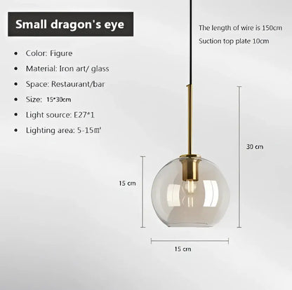 Industrial smoked glass and brass pendant light with transparent globe designed as a small dragon eye decorbites industrial glass pendant
