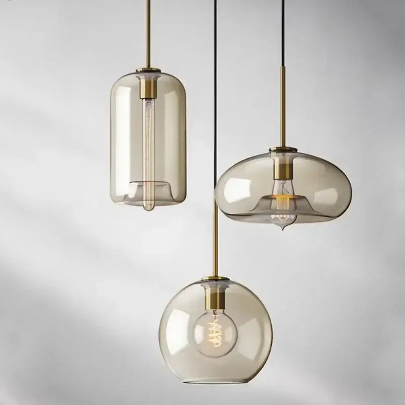 Three modern industrial glass pendant lights with smoked glass shades and brass accents for dining room decorbites industrial glass
