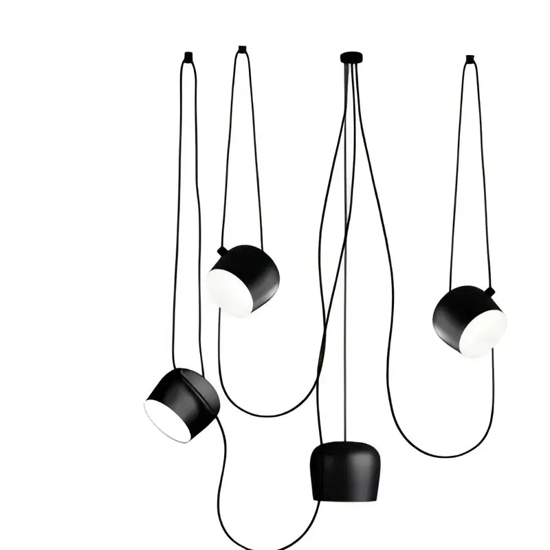 Black cylindrical pendant lamp with white interiors suspended by thin cords decorbites industrial spider pendant