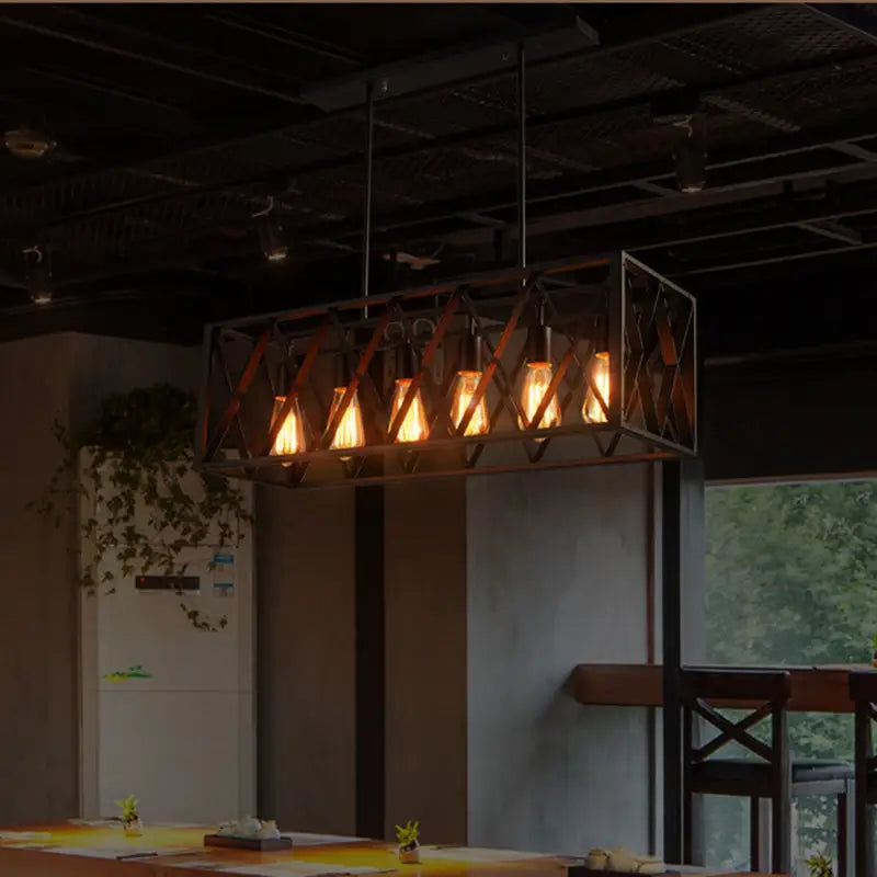 Industrial style black ironwork rectangular island light with dark metal frame and glowing filament bulbs for kitchen