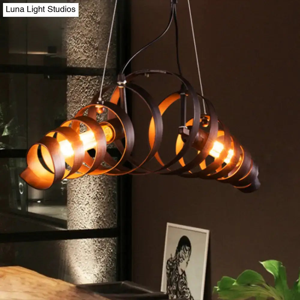 Industrial style dark bronze spiral metal pendant light with illuminated bulbs casting warm amber glow for dining room