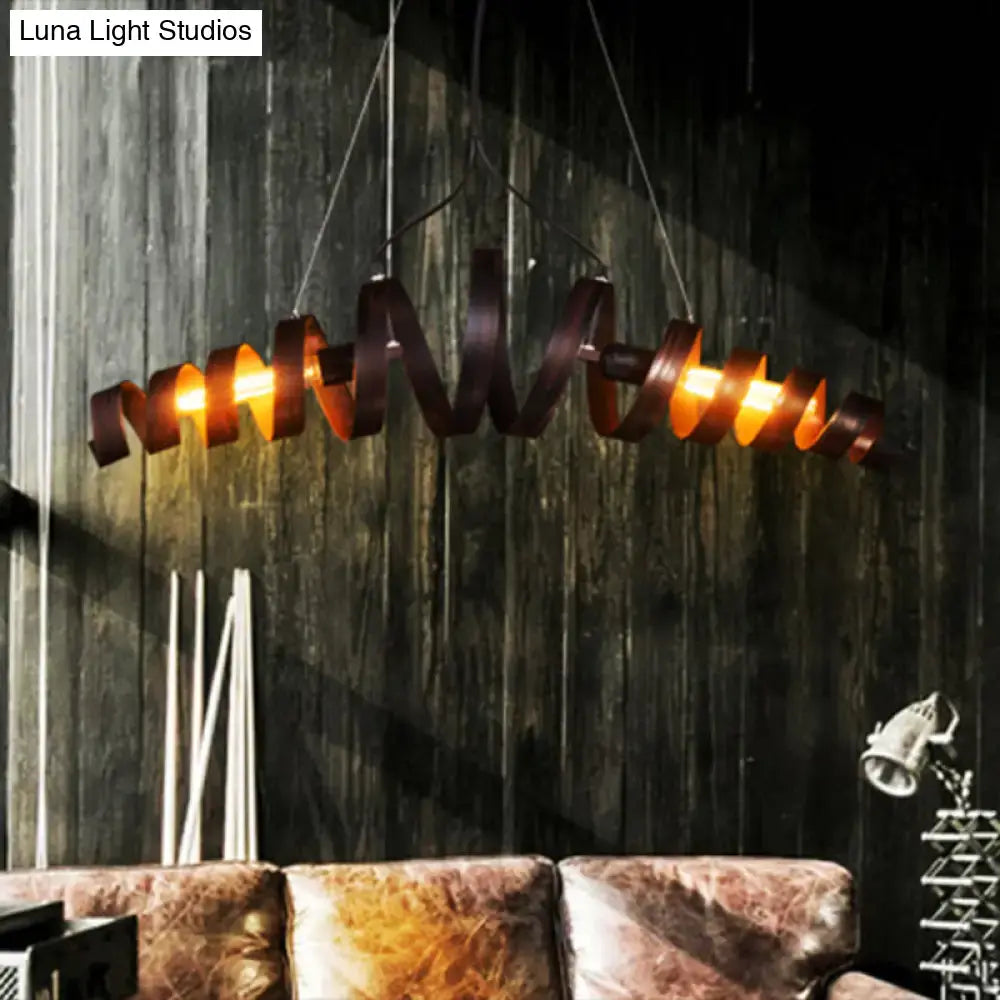 Industrial style spiral metal pendant light with warm amber glow dark bronze finish for dining room or island lighting