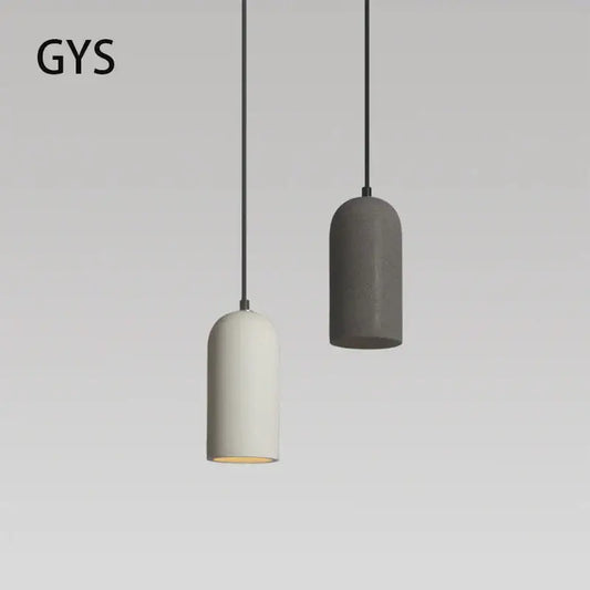 Two minimalist pendant lights in matte white and dark gray concrete with black cords in decorbites industrial style led chandelier