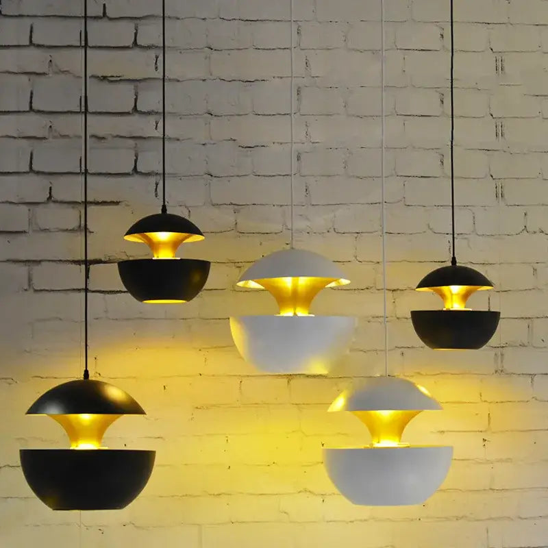 Industrial style led pendant light with matte black exterior and gold flower-like interior for modern kitchen use