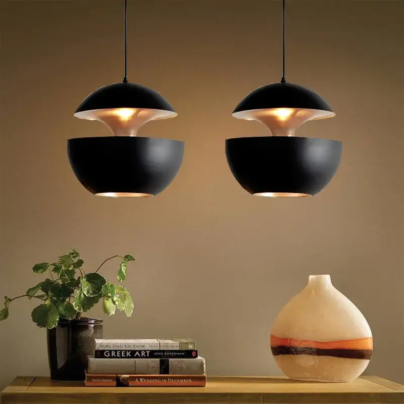 Black matte industrial style led pendant light with split-dome design and warm interior glow for kitchen use