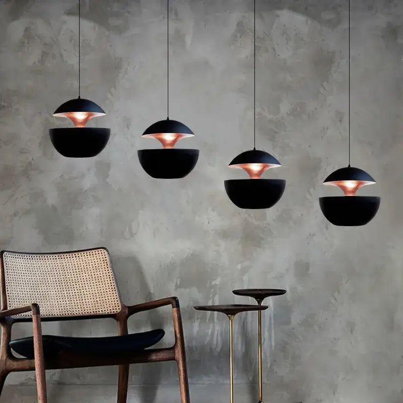Black and copper industrial style led pendant light with a matte black kitchen split dome and sleek modern design