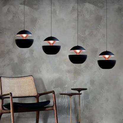 Black and copper industrial style led pendant light with a matte black kitchen split dome and sleek modern design