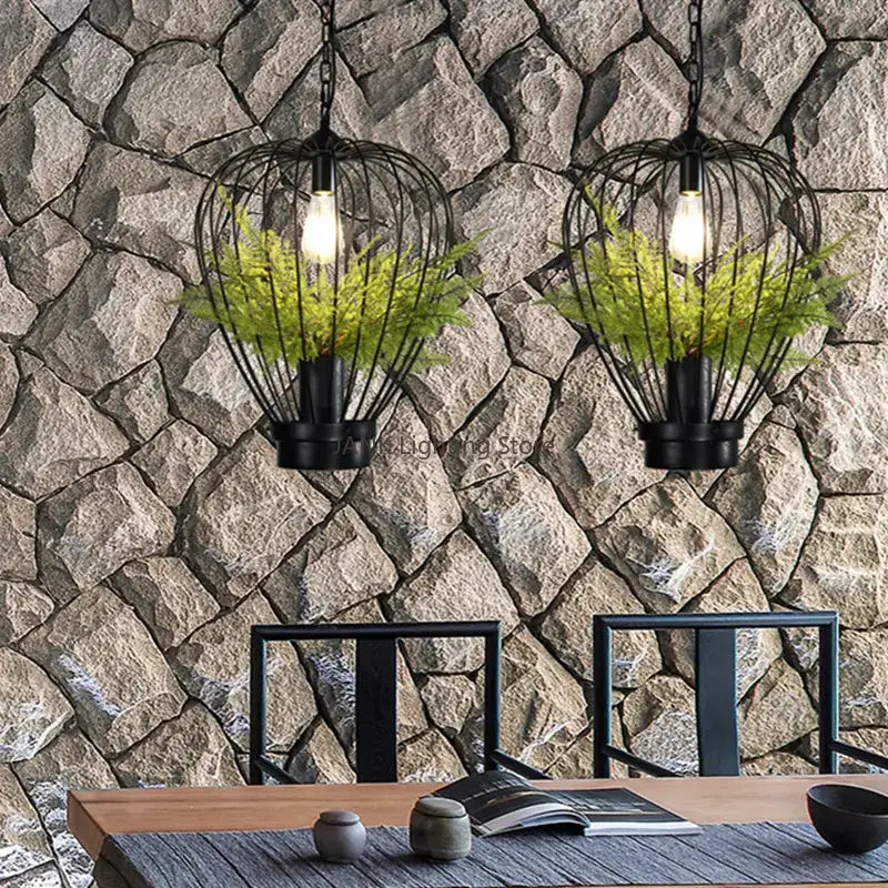 Black wrought iron pendant lamp with exposed bulbs and green ferns for decorbites industrial style planting decor