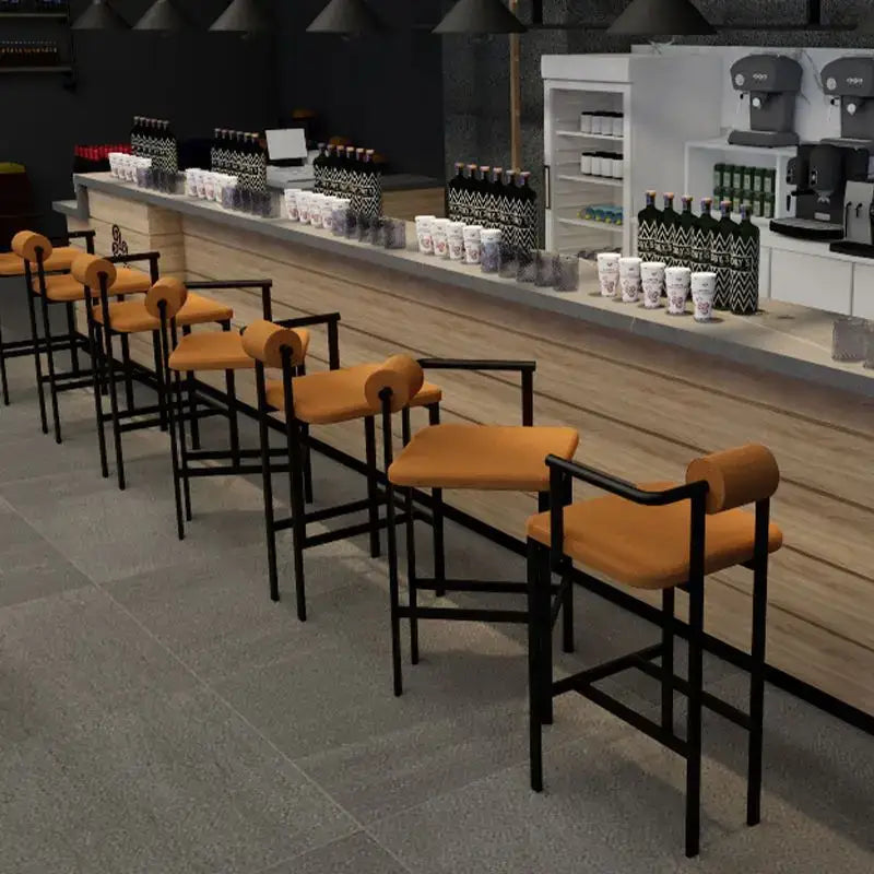 Modern industrial style bar chair with black metal frame and orange upholstered seat for decorbites industrial style use
