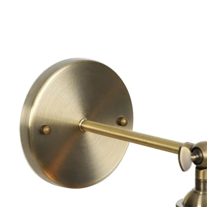 Brass-finished industrial vintage wall sconce with adjustable articulated arm and circular mounting plate for bedroom decorbites industrial vintage led lighting