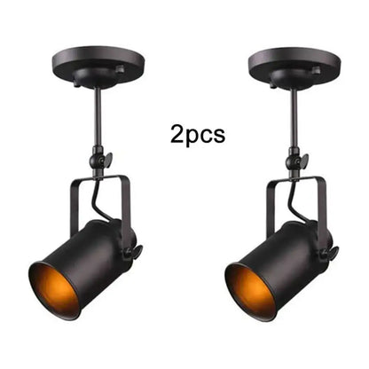 Industrial vintage black ceiling lights with adjustable matte black spotlights and warm amber interior by decorbites