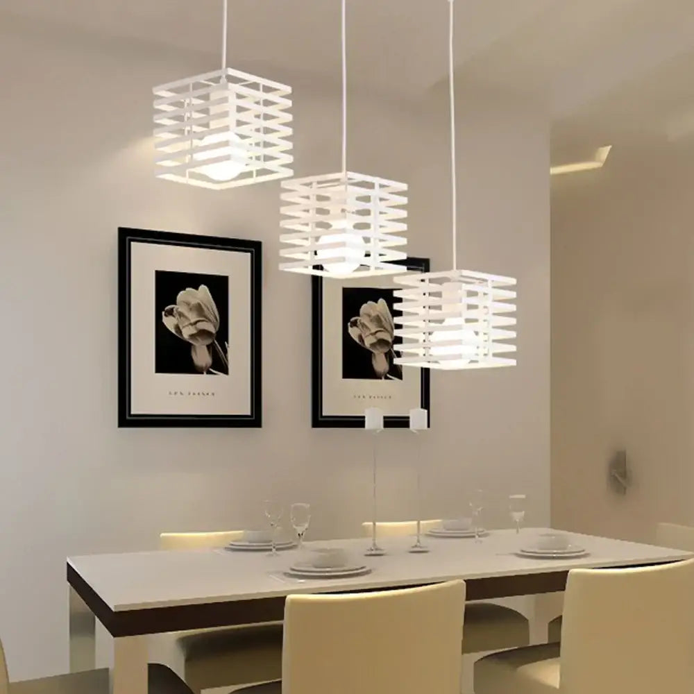 Three white cube-shaped pendant lights with geometric lattice design complement decorbites industrial vintage led dining room decor