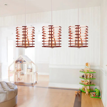 Three copper-colored cylindrical pendant lights with woven cage design in decorbites industrial vintage led style