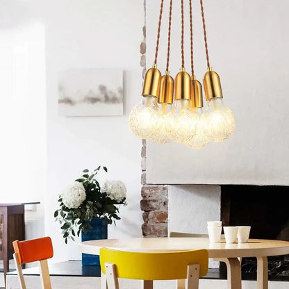 Gold-toned industrial vintage pendant light with exposed filament bulbs and twisted brown cords for dining room decorbites industrial vintage