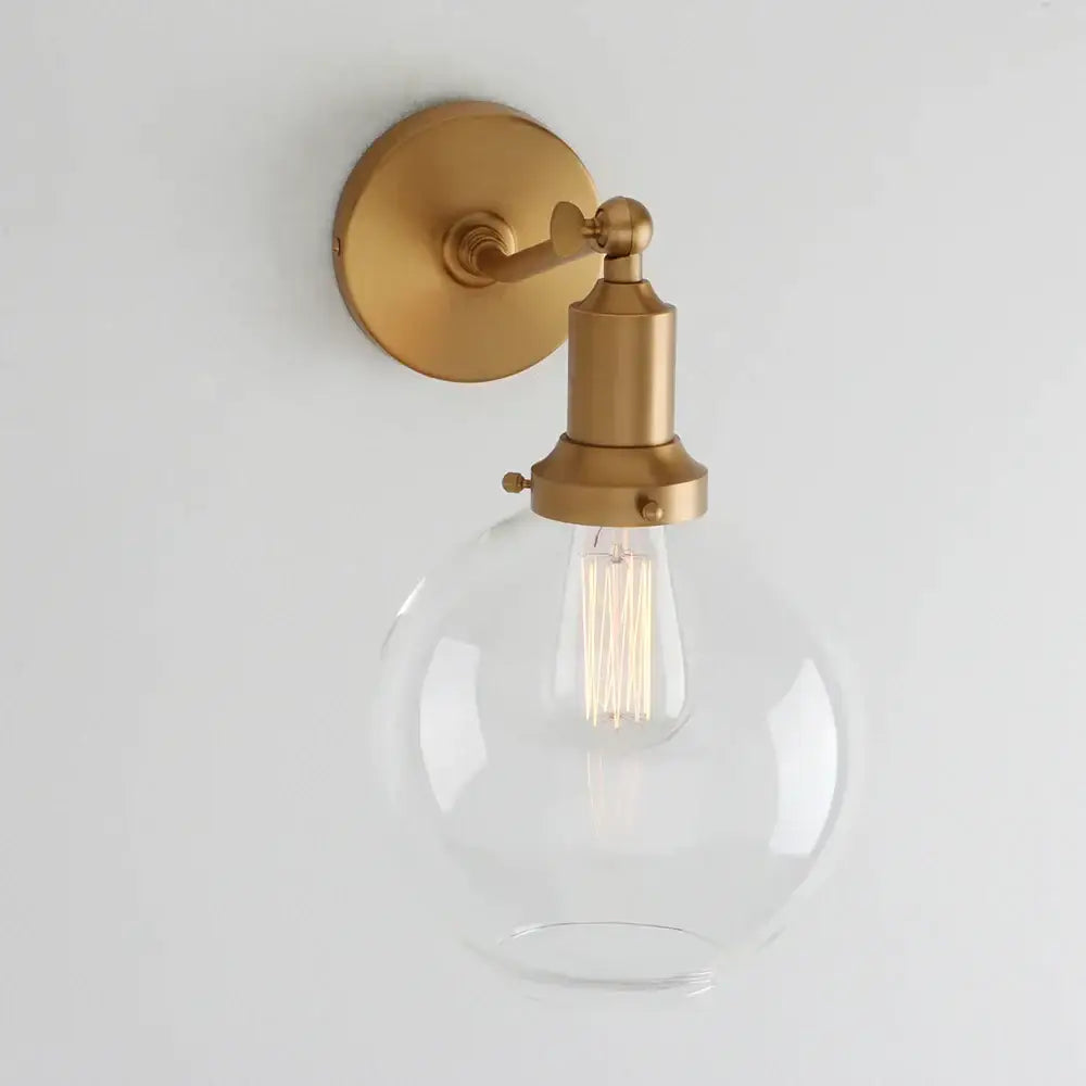 Gold-finished decorbites industrial vintage wall sconce with clear glass globe and exposed filament bulb for bedroom decor
