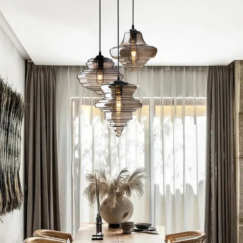 Three tiered industrial vintage glass pendant lamp with amber and clear smoked glass and exposed filament bulbs