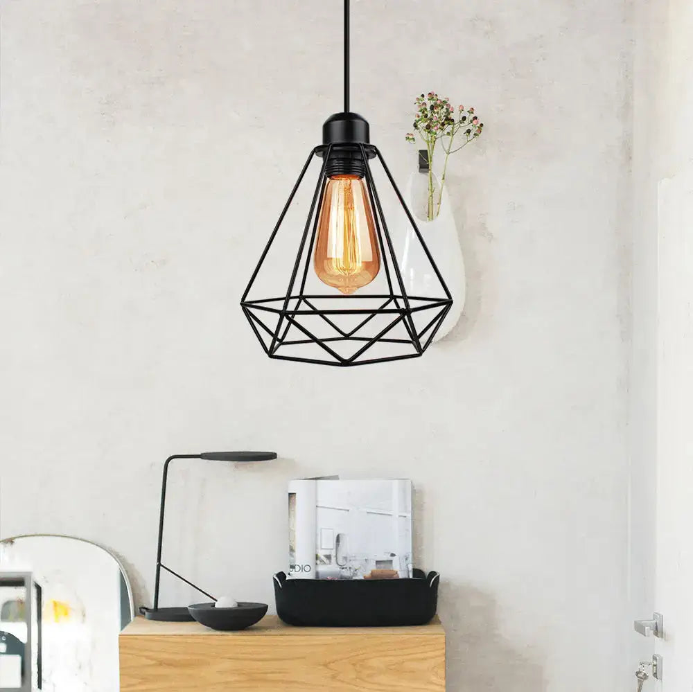 Black geometric wireframe pendant light with exposed amber filament bulb in decorbites industrial vintage iron style decor