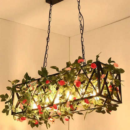Black metal geometric pendant lamp with artificial green vines and pink roses for industrial vintage loft decorbites interior