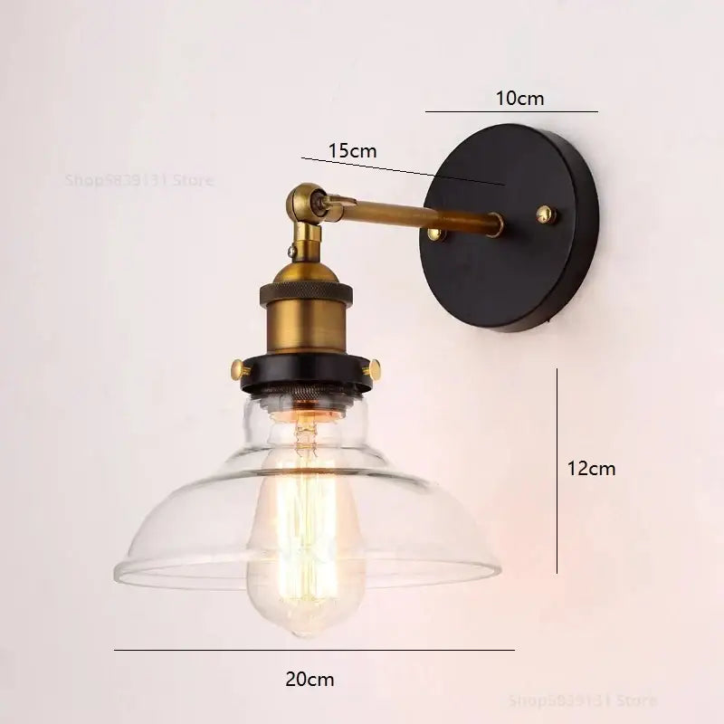 Industrial vintage loft wall lamp with brass arm, black base, clear glass dome, and exposed edison bulb by decorbites industrial vintage