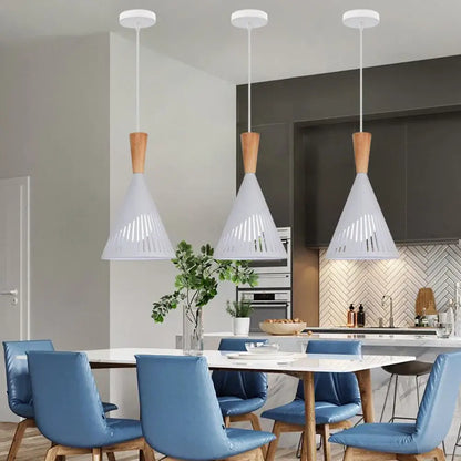 Three white conical pendant lights with wooden tops hang above a table in decorbites industrial vintage pendant light style