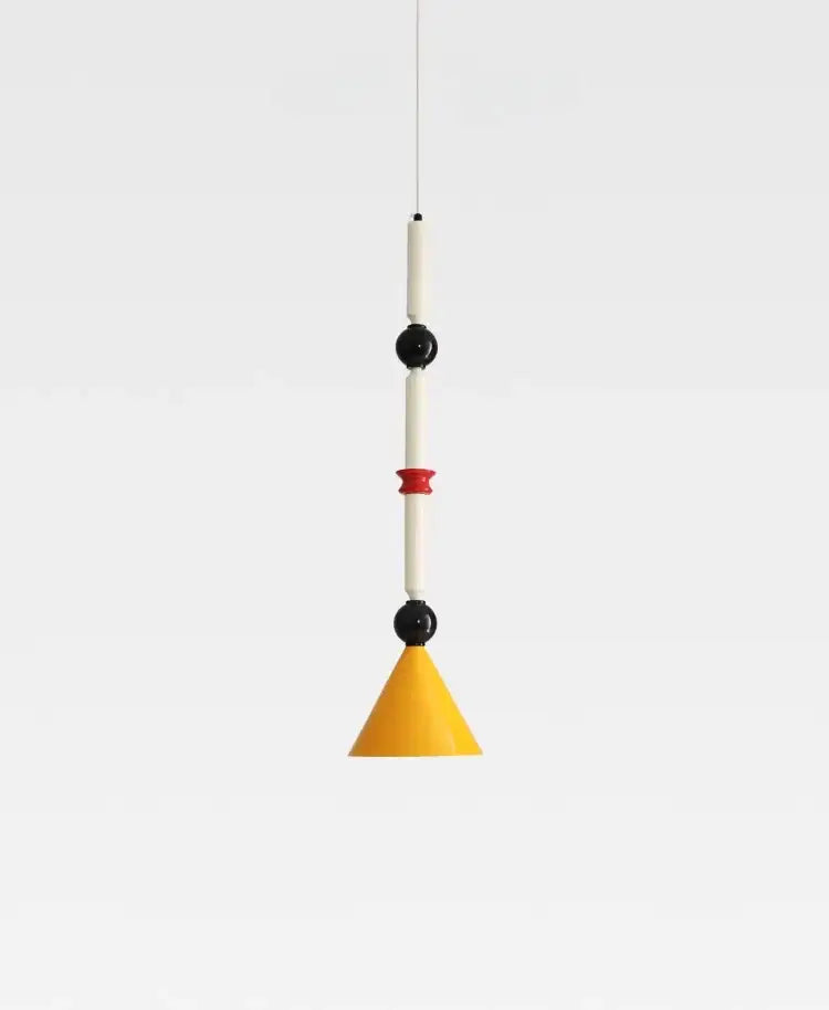 A modern industrial vintage pendant light with yellow conical shade, white cylinders, and black spherical accents by decorbites