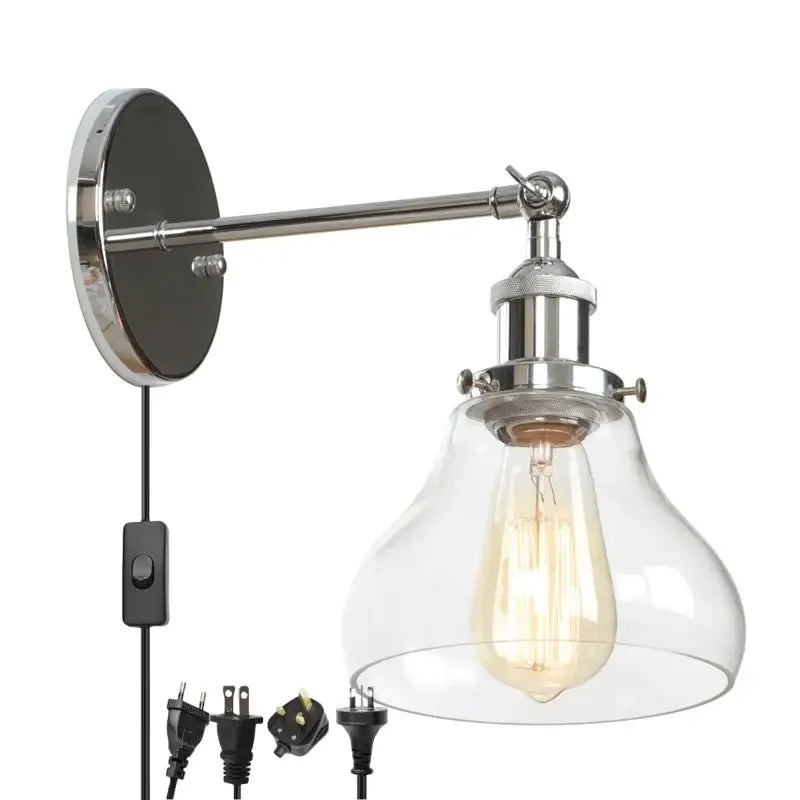 Chrome-finished industrial vintage silver wall lamp with clear glass bell-shaped shade and exposed edison bulb by decorbites