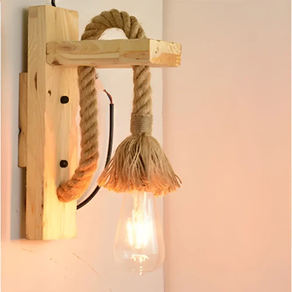 Rustic wooden wall lamp with thick natural rope, frayed tassel, and exposed Edison bulb decorbites industrial vintage design