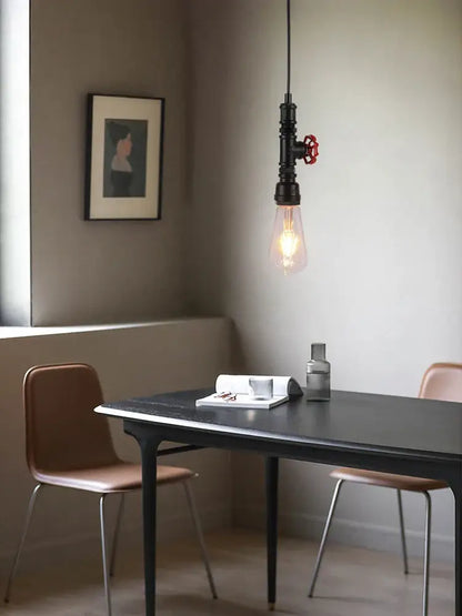 Industrial water pipe chandelier kitchen pendant light with black pipe fixture, red valve handle, and exposed edison bulb