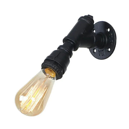 Industrial water pipe wall sconce in black and brass with glowing amber filament bulb by decorbites industrial water decor