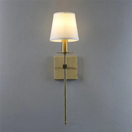 A sleek industrial white wall lamp with a brass finish and cylindrical fabric shade for bathroom decorbites industrial white