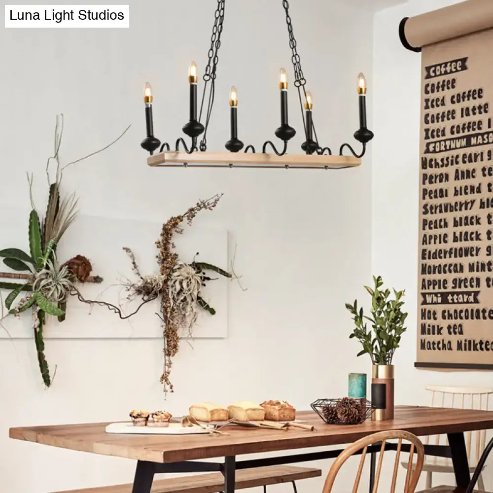 Black metal chandelier with light wood bar and six candle style bulbs for dining room style island light