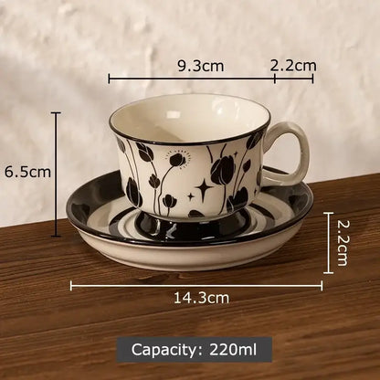 A white ink flowers ceramic cup and saucer set with black floral and star patterns for dining room decorbites ink flowers
