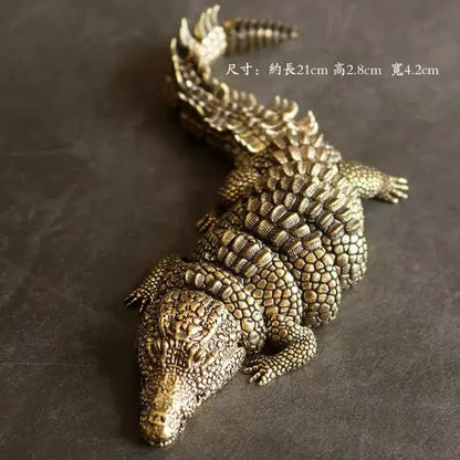 Intricate decorbites brass crocodile sculpture with bronze textured scales and spiked tail for living room decor