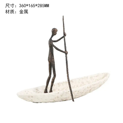 Bronze-colored metal horse decoration featuring a stylized figure on a textured white boat holding a long pole